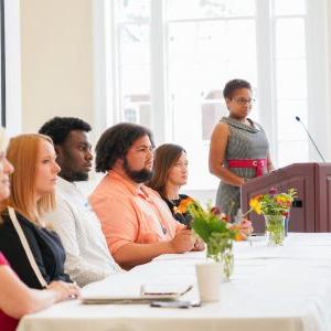 Panelists at a UM Inclusion conference listen to an audience member.